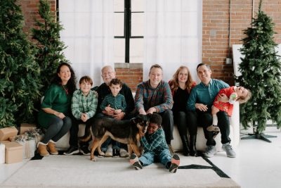 A large family group photographed together at Christmas, John seated in the middle